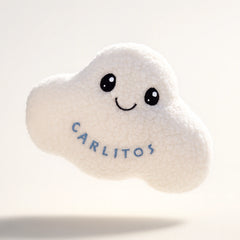 White cloud-shaped plush toy with 'Carlitos' embroidery on a light gray background