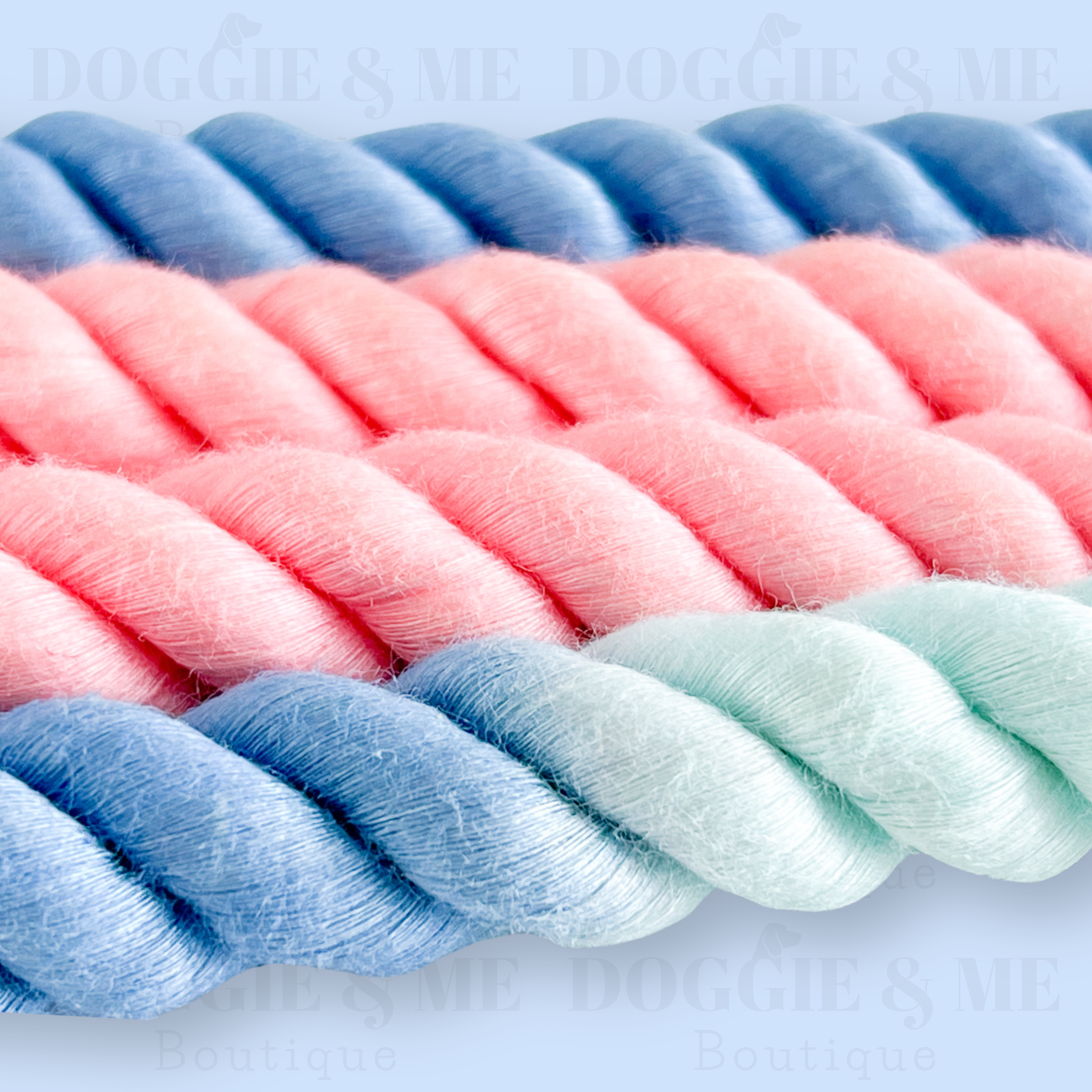 Close-up of a braided ombre blue-pink cotton dog leash with tan leather joints, showcasing its soft yet durable texture and gold snap hook. Available in various colors and lengths from 4ft to 5.74ft.