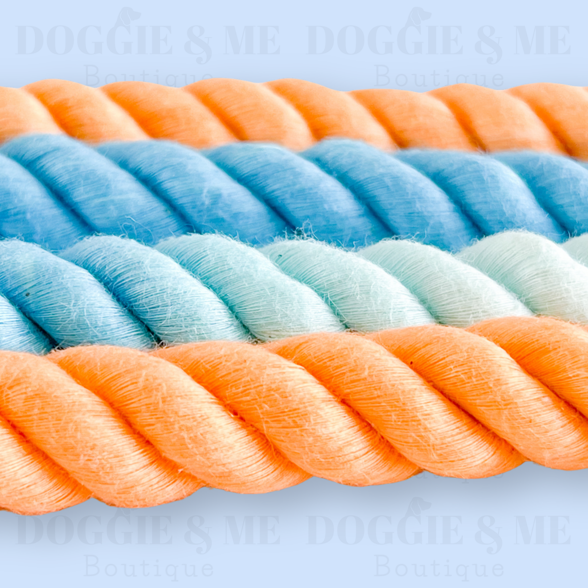 Close-up of a braided ombre blue-orange cotton dog leash with tan leather joints, showcasing its soft yet durable texture and gold snap hook. Available in various colors and lengths from 4ft to 5.74ft.