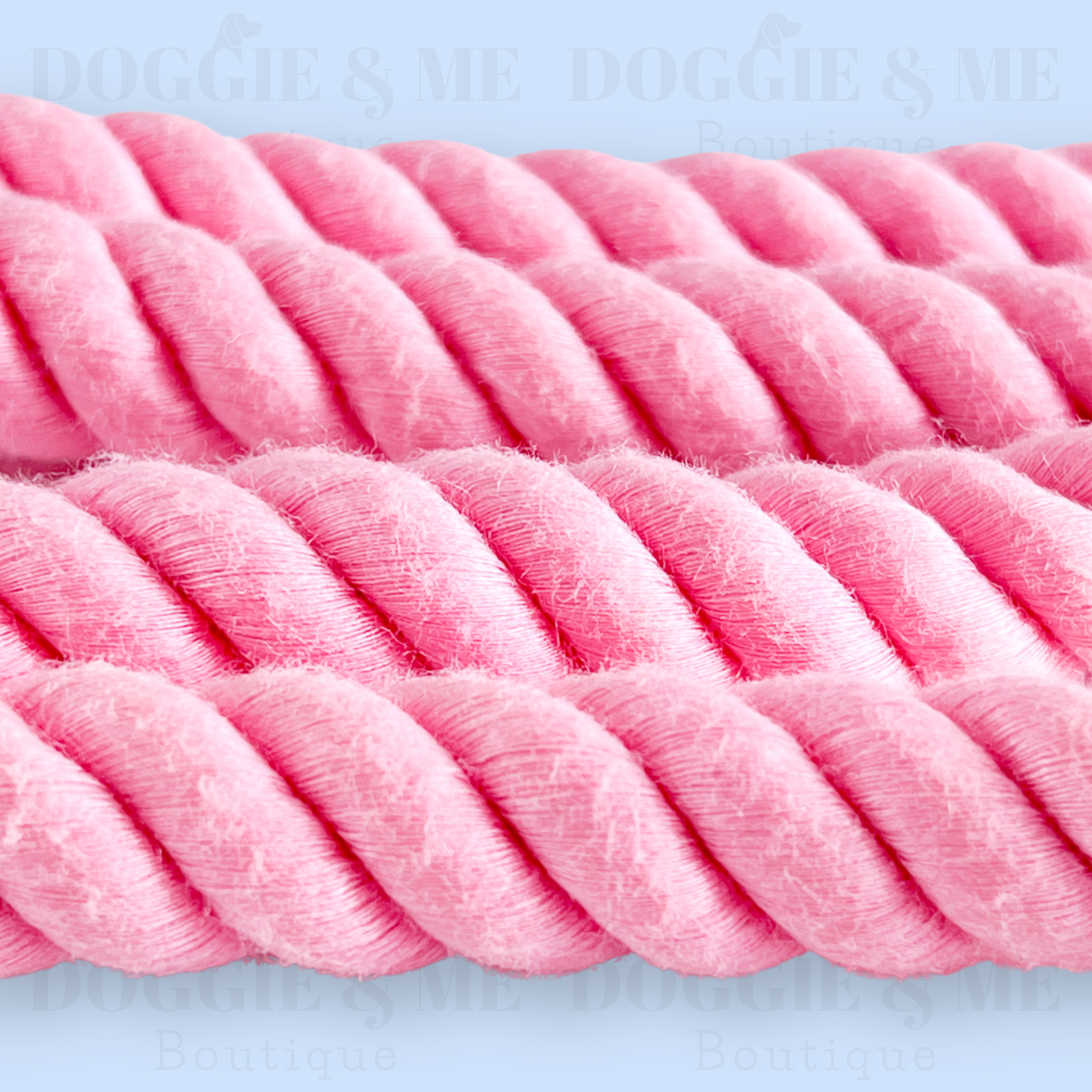 Close-up of a braided pink cotton dog leash with tan leather joints, showcasing its soft yet durable texture and gold snap hook. Available in various colors and lengths from 4ft to 5.74ft.