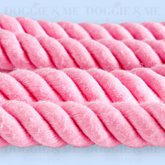 Close-up of a braided pink cotton dog leash with tan leather joints, showcasing its soft yet durable texture and gold snap hook. Available in various colors and lengths from 4ft to 5.74ft.