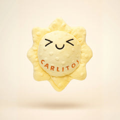 Sun-shaped plush toy with 'Carlitos' branding on a beige background