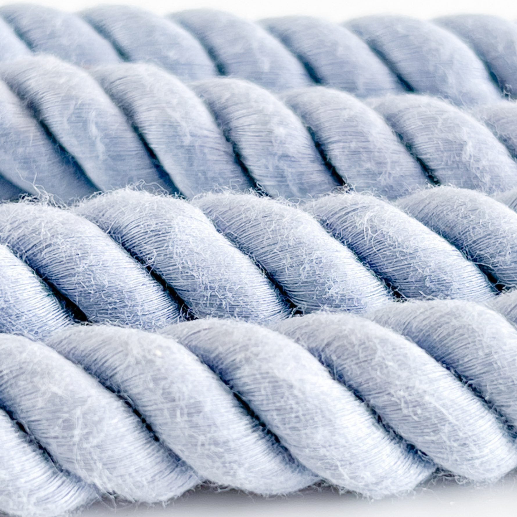 Close-up of a blue braided rope on a white background
