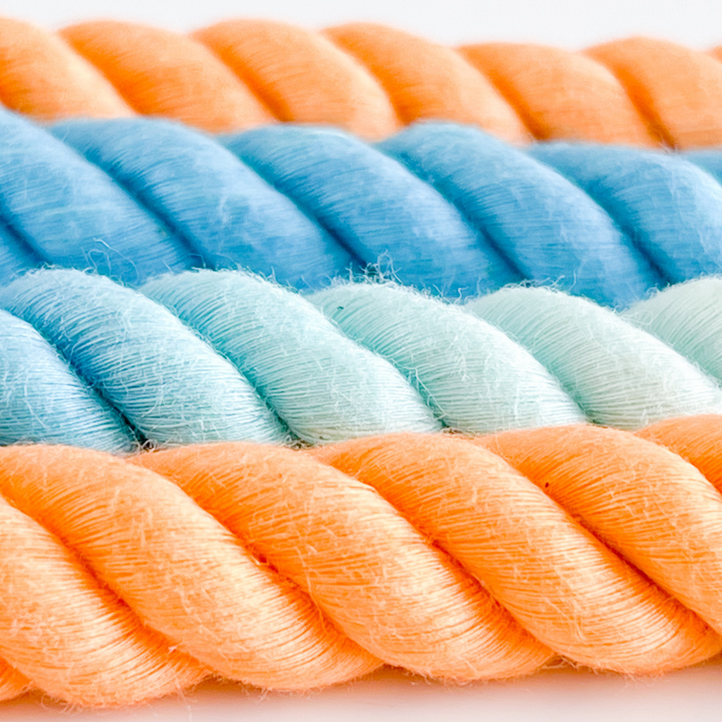 Close-up of multicolored rope with blue, green, and orange hues.
