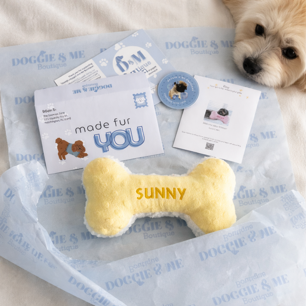 Dog toy with 'SUNNY' on it on a branded packaging with a small dog peeking in.