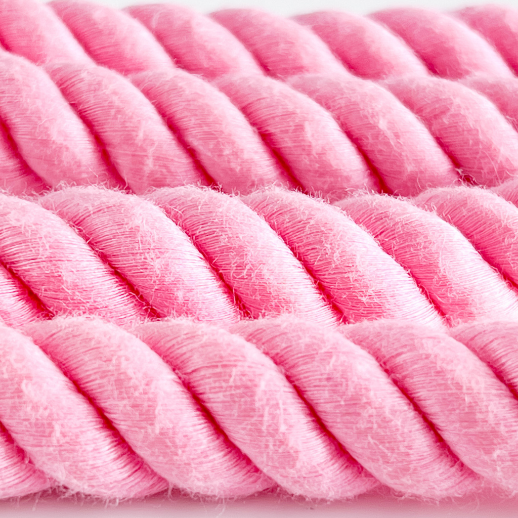 Close-up of pink textured yarn on a white background